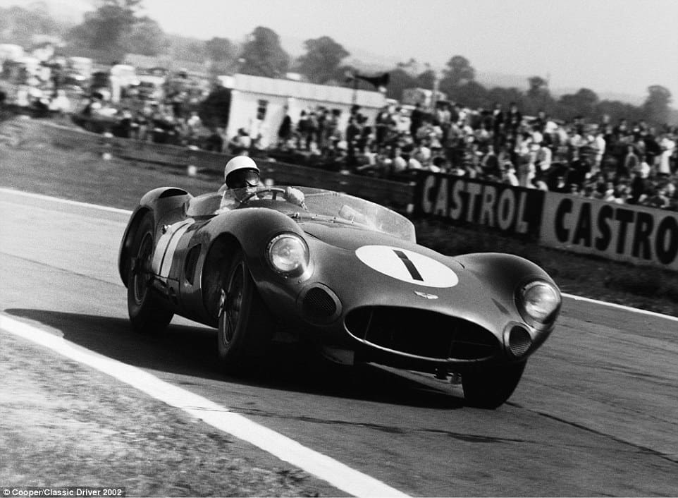 Stirling Moss pictured behind the wheel of an Aston Martin DBR1 - a car he took to victory in 1959