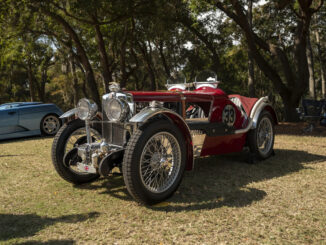 A vintage red 1930s MG race car with wire wheels and the number 33 on display under the live oaks at the Hilton Head Island Concours d'Elegance