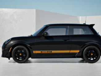 Side profile of the black MINI 1998 GT Edition with orange lower-body stripes and black JCW wheels.