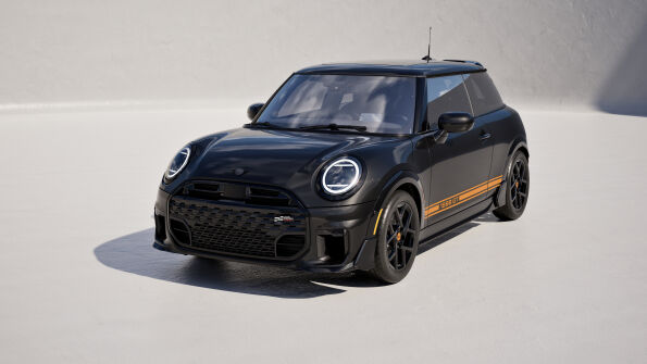 Front three-quarter view of the black MINI 1998 GT Edition with orange GT side stripes.