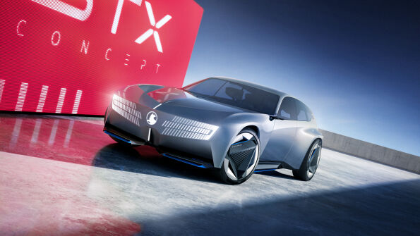 Silver Vauxhall STX Concept estate car, front three-quarter view against a red STX backdrop