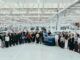 Bentley 2027 early careers cohort gathered around a blue Bentley inside the Crewe factory