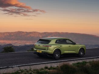 Rear three-quarter view of the all-new Bentley Torcal in light green on a mountain road at sunset