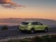 Rear three-quarter view of the all-new Bentley Torcal in light green on a mountain road at sunset