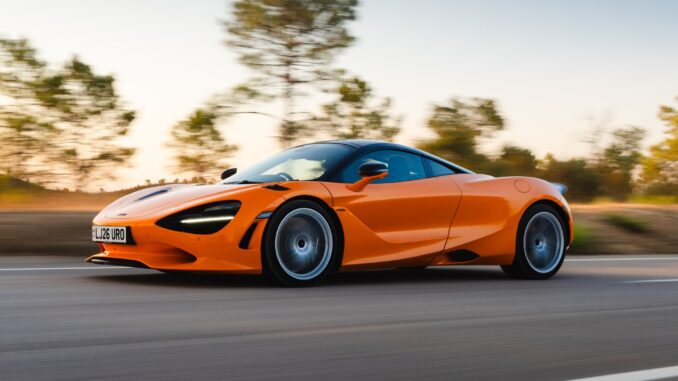 McLaren 750S coupe driving on a country road at speed