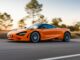 McLaren 750S coupe driving on a country road at speed