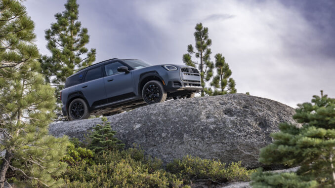 MINI Countryman Untamed Edition climbing over a boulder on a forest trail