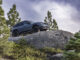 MINI Countryman Untamed Edition climbing over a boulder on a forest trail