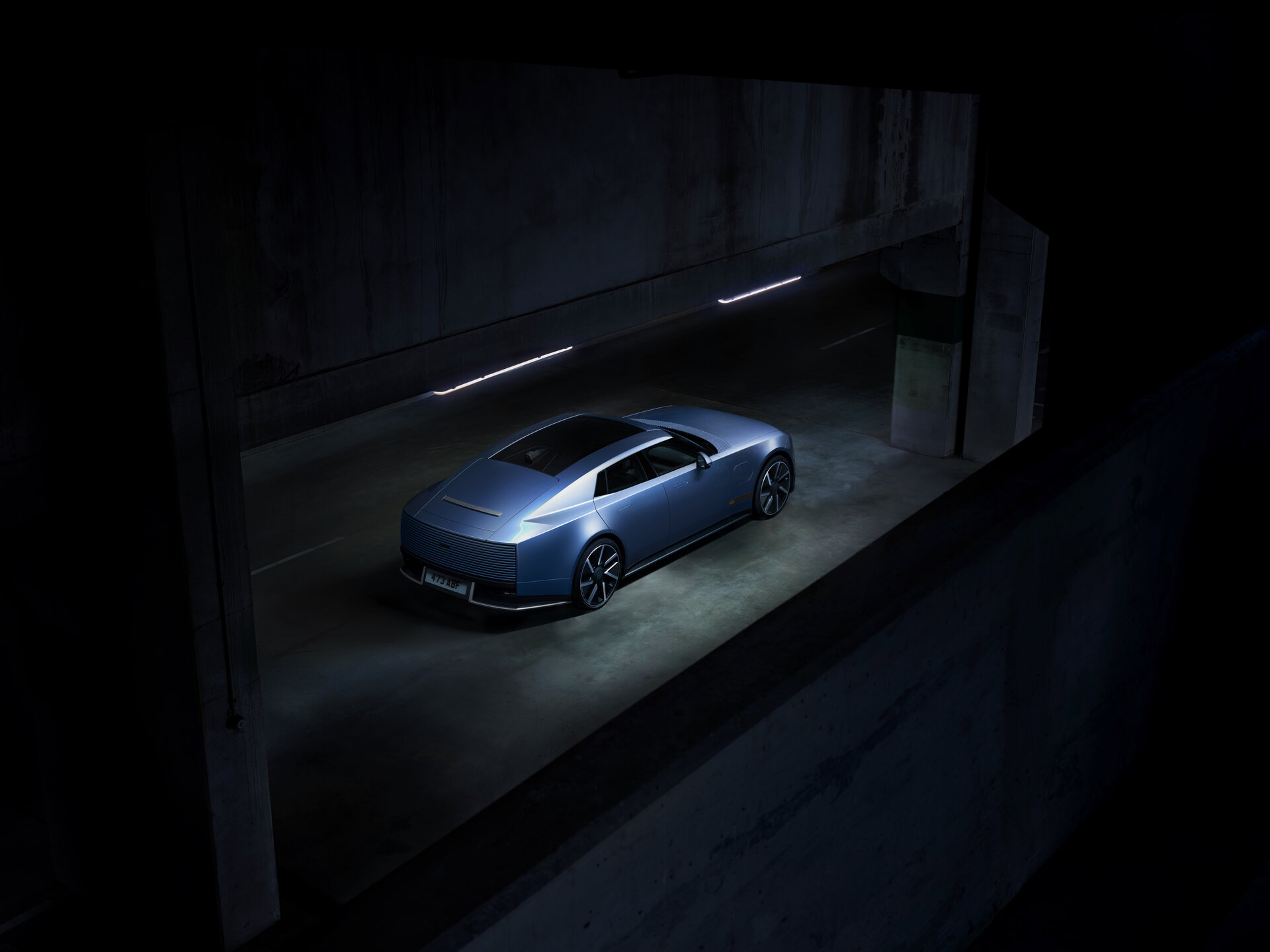 Jaguar Type 01 rear three-quarter view in blue, showing its fastback silhouette