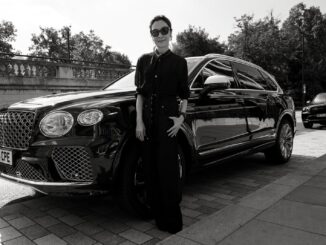 Michelle Yeoh standing beside a Bentley Bentayga, black and white portrait