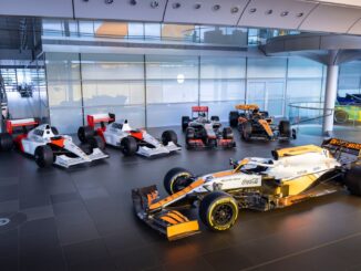 Five McLaren Formula 1 cars lined up inside the McLaren Technology Centre, led by the 2021 MCL35M