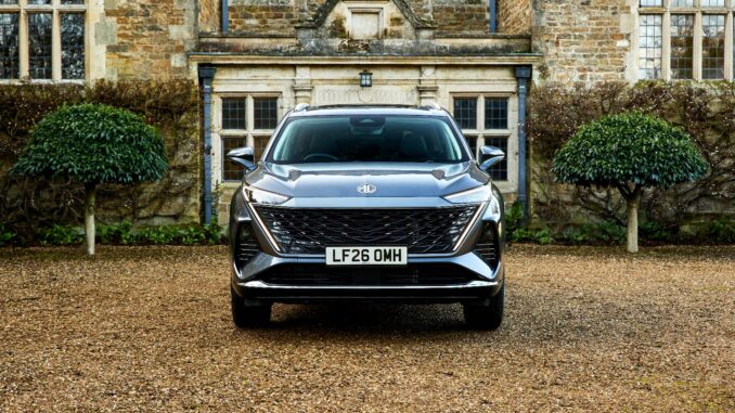 The MG MGS9 PHEV in Camden Grey parked on gravel in front of a stone country house, front view