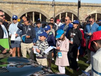 Matthew Ivanhoe describes his 1952 Jaguar C-Type to Hagerty Youth Judges at the Audrain Concours