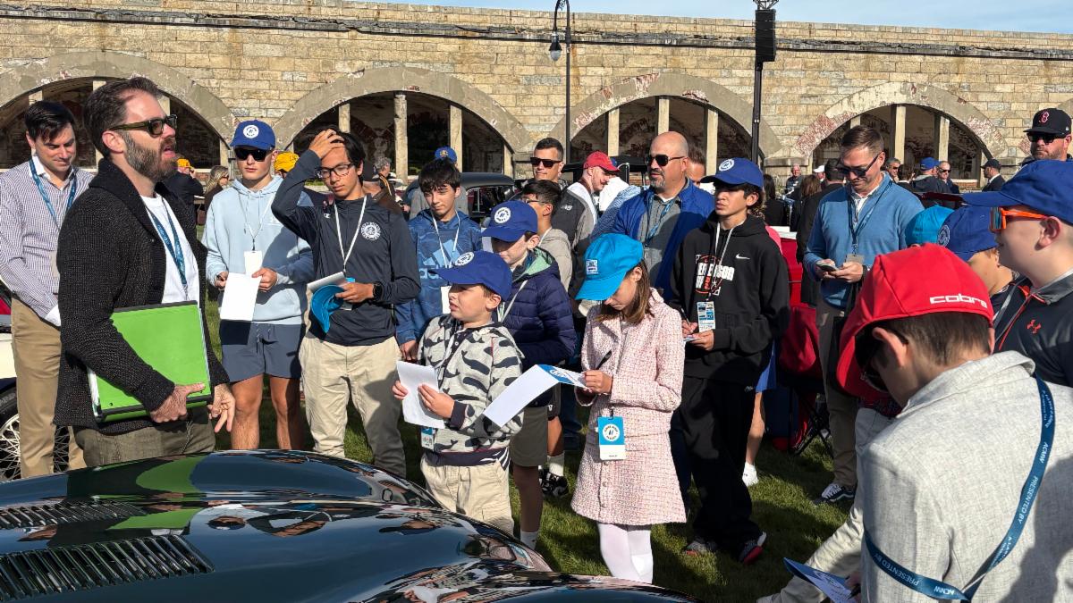 Matthew Ivanhoe describes his 1952 Jaguar C-Type to Hagerty Youth Judges at the Audrain Concours